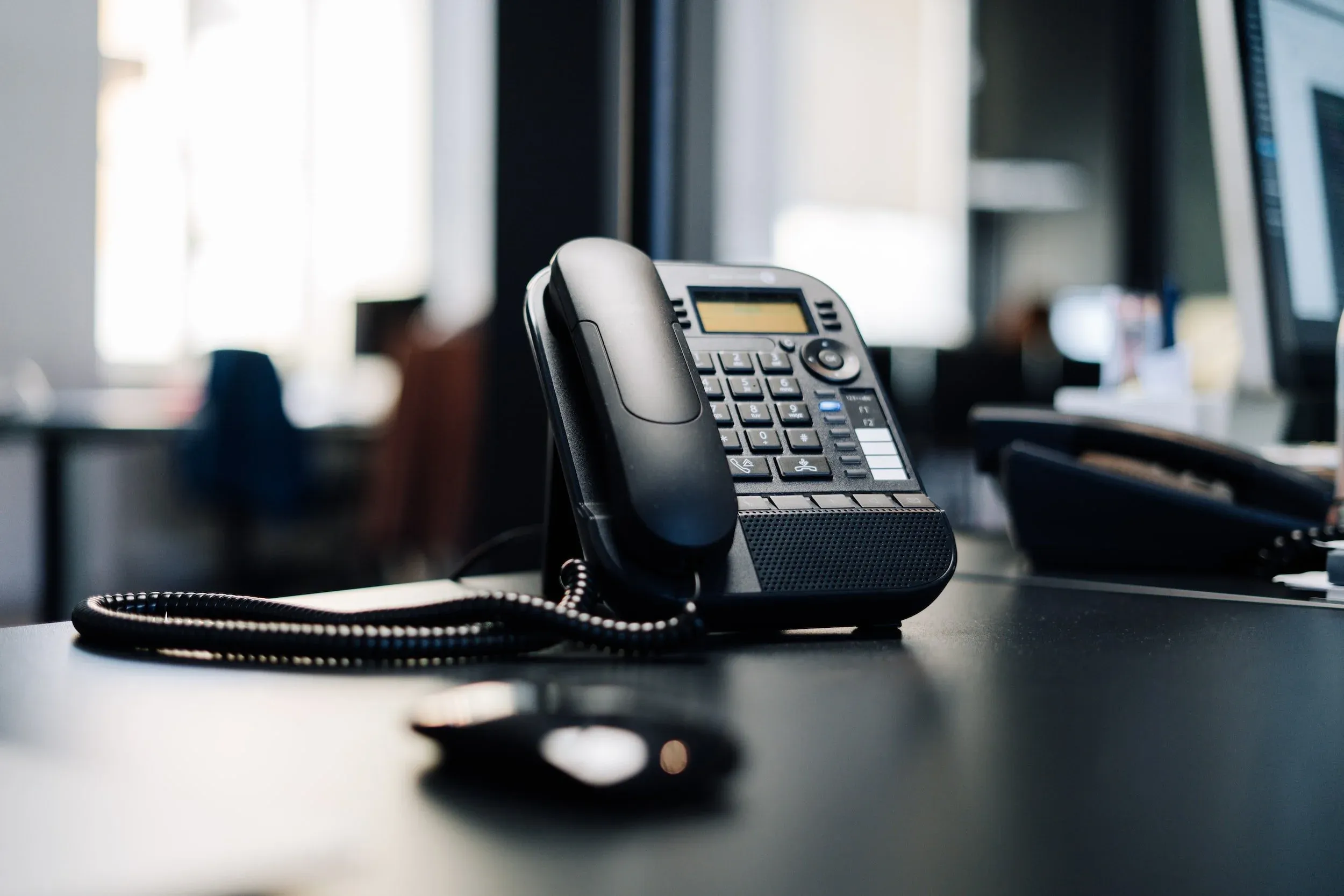 A desk phone in an office.